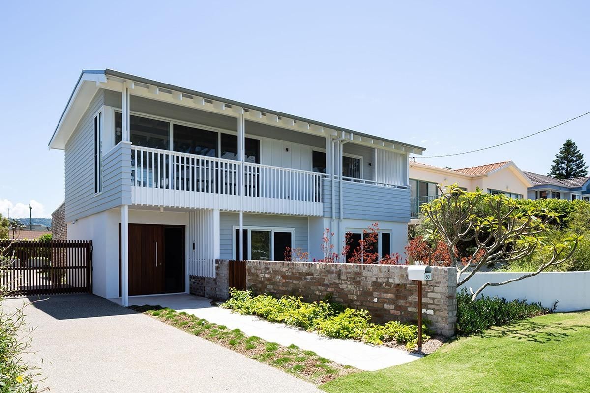 A Large White House With A Lot Of Windows And Balconies — QBC Constructions In Shellharbour, NSW