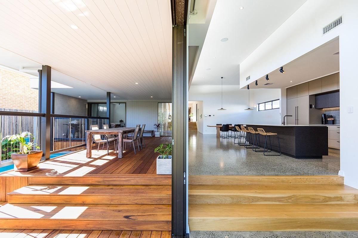 There Is A Sliding Glass Door Between The Living Room And The Kitchen — QBC Constructions In Werri Beach, NSW