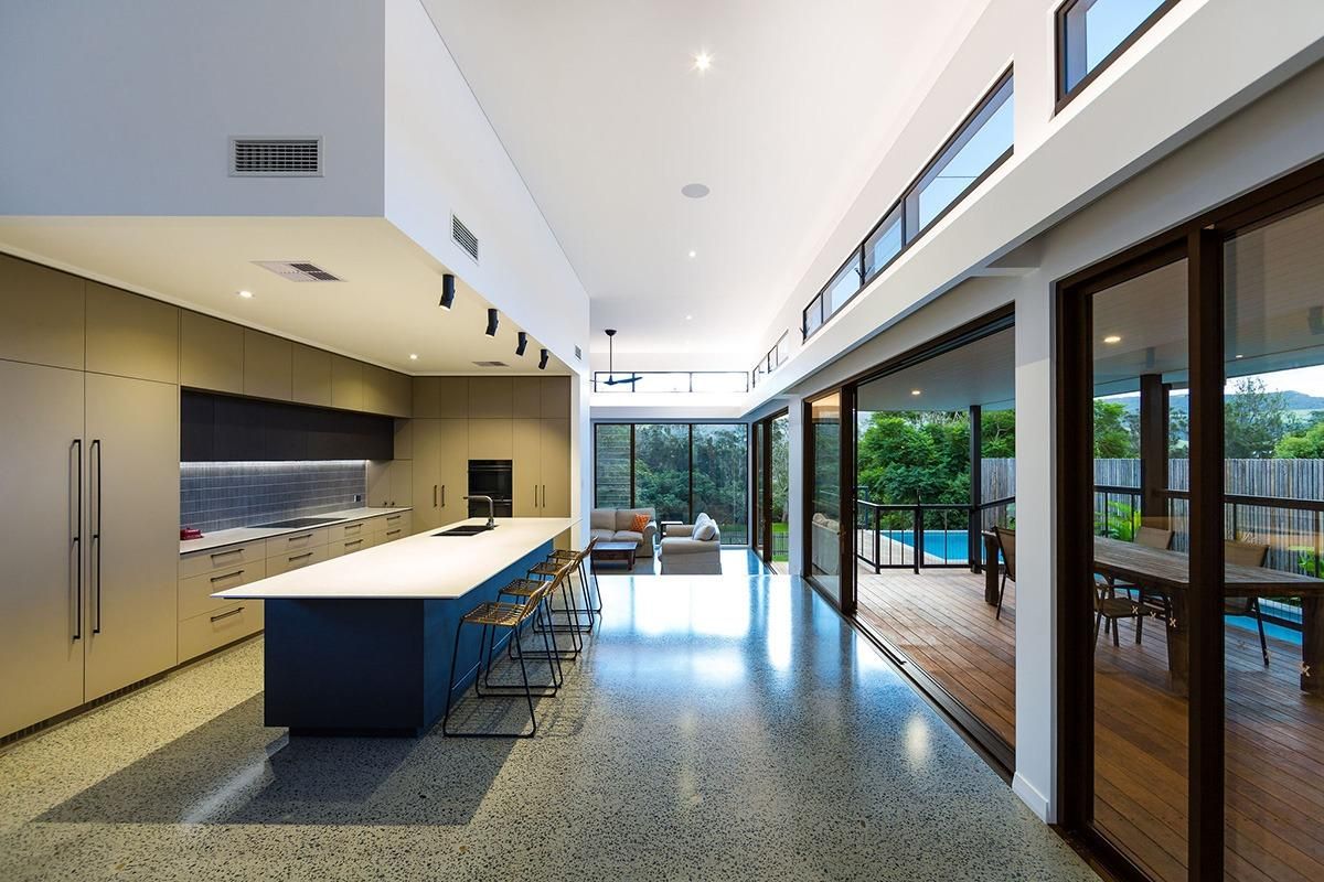 A Kitchen With A Large Island And Sliding Glass Doors — QBC Constructions In Werri Beach, NSW