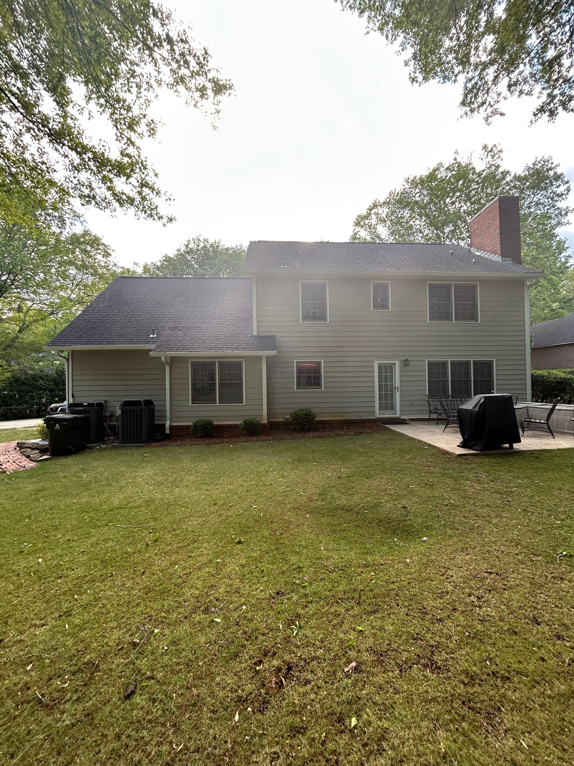 A large house with a large lawn in front of it.