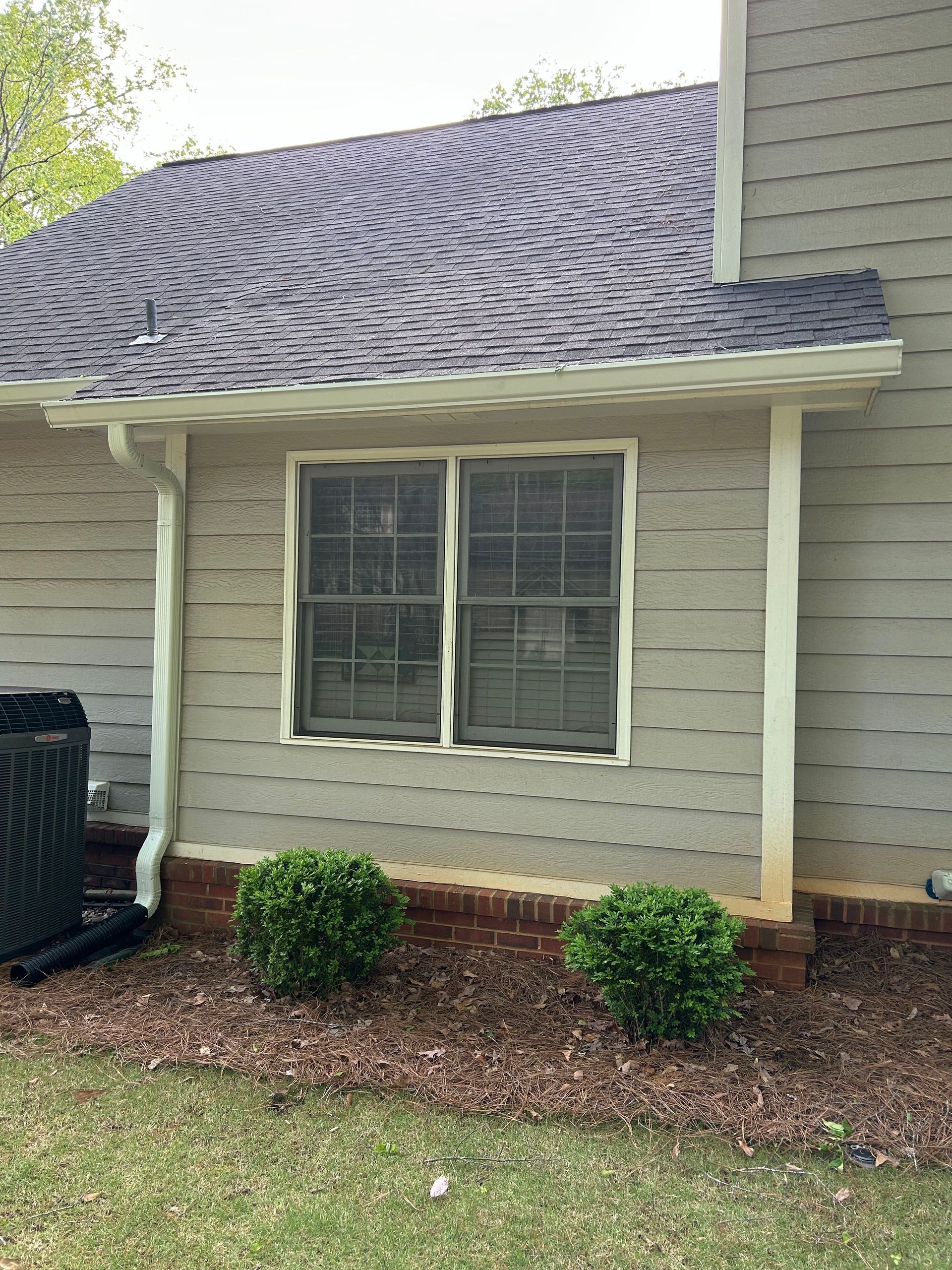 A house with a broken window and a broken roof.