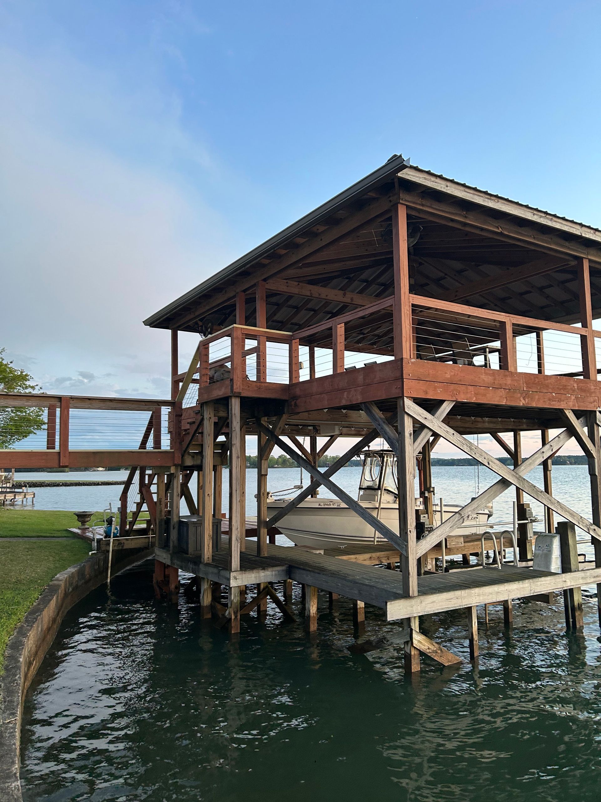 A boat is docked in a wooden dock next to a body of water.