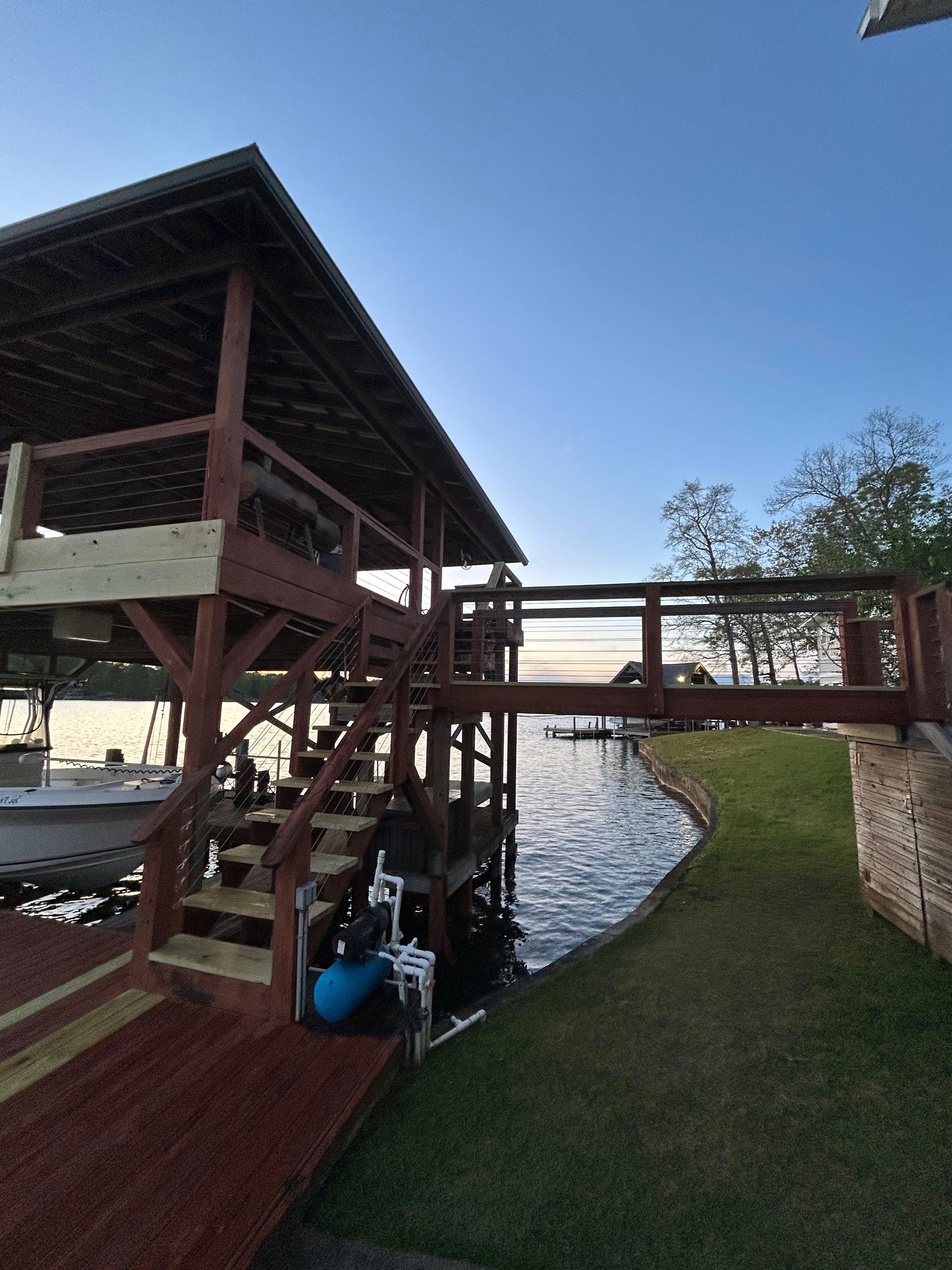 A wooden dock with stairs leading to a boat
