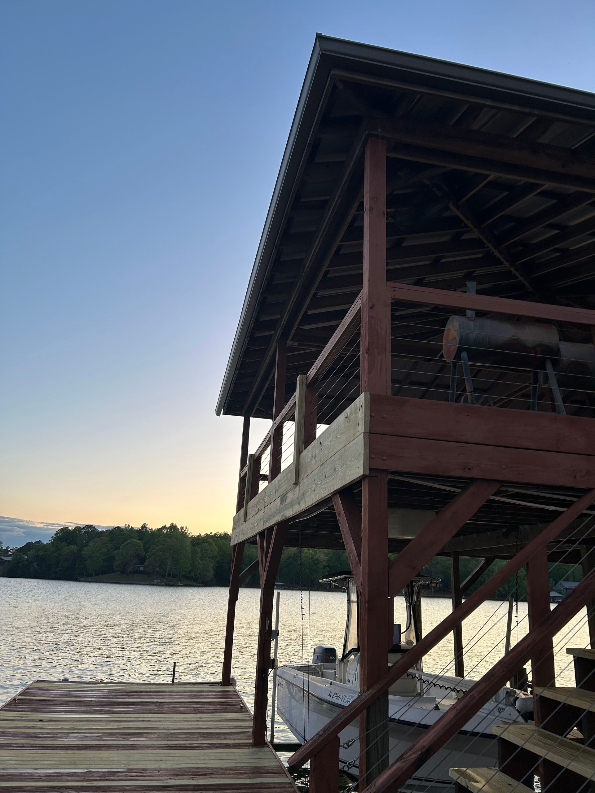 A boat is docked at a dock with stairs leading up to it.