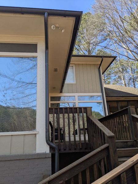 A house with a balcony and stairs leading up to it