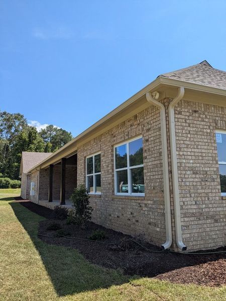 A brick house with a lot of windows on a sunny day