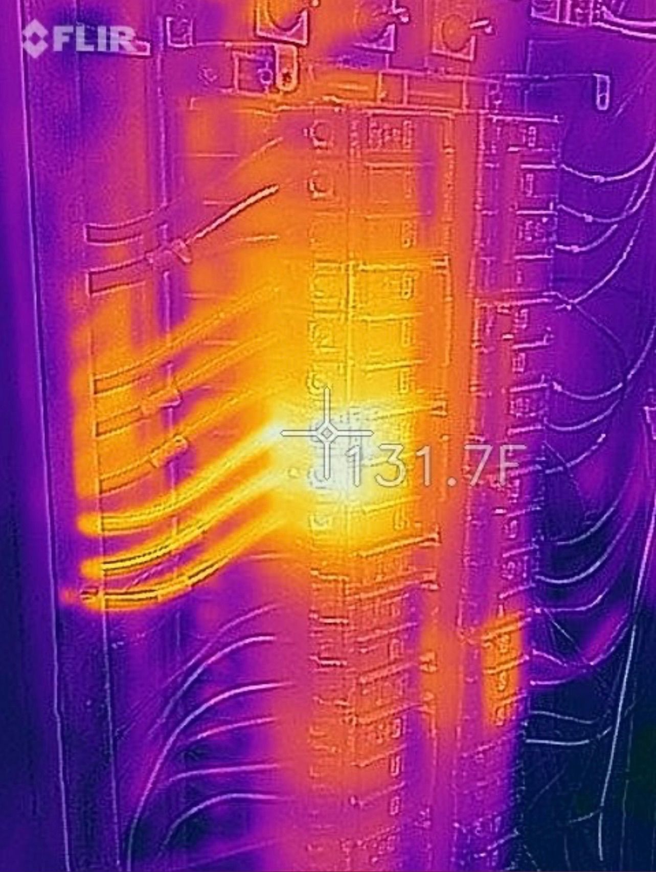 Thermal image of electrical panel showing a hot spot (131.7°F) in the center, indicating a potential electrical issue.