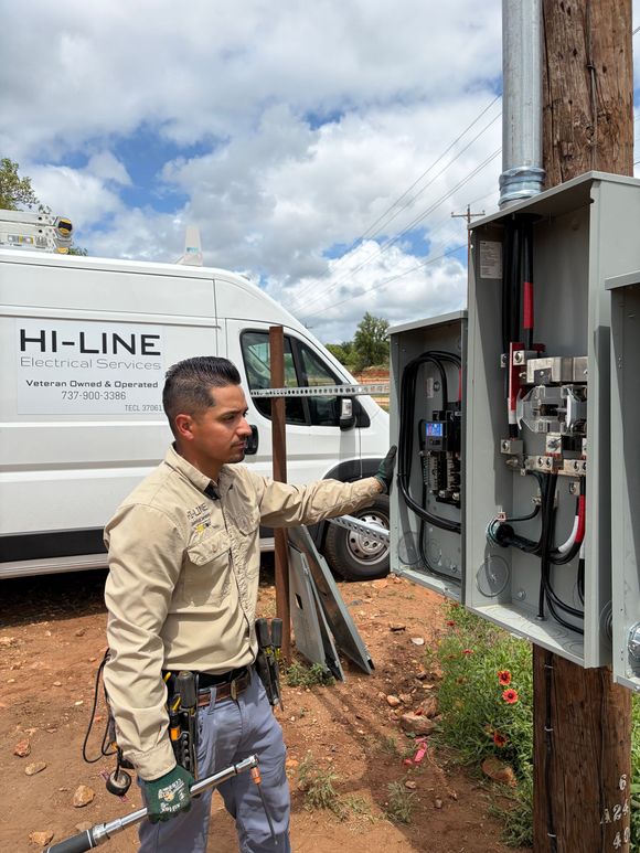 A curved white shelf with spotlights embedded in the ceiling.  Warm light reflects on the beige walls.