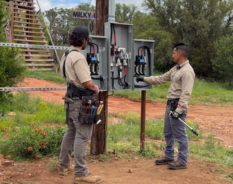 White ceiling with recessed lights, with sheer curtains and a light beige wall in the background.