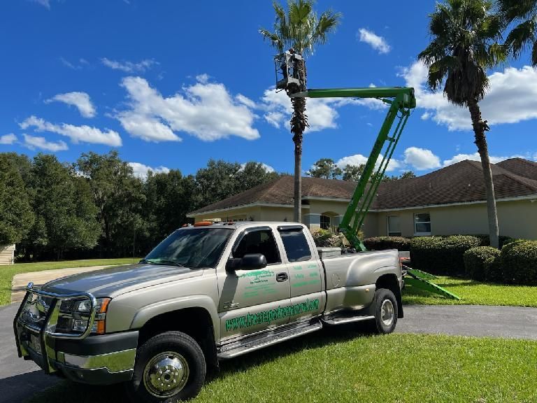 A truck with a crane attached to it is parked in front of a house.