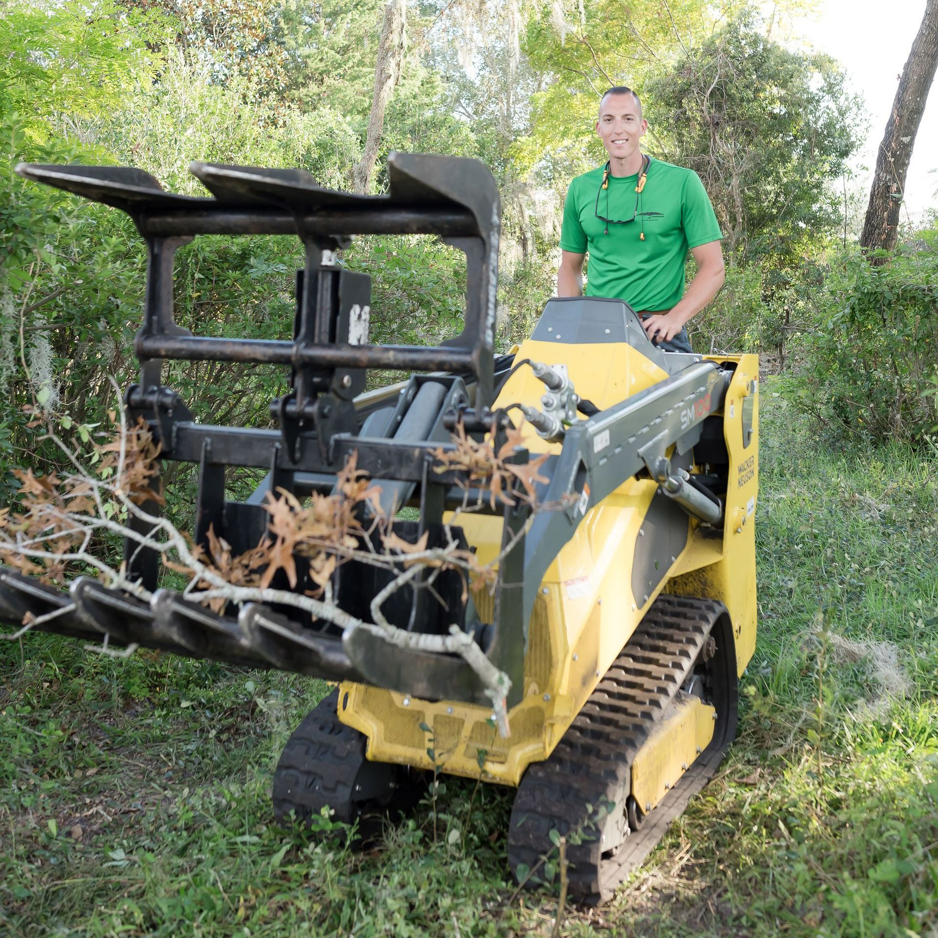 A man is cutting a tree with a crane.