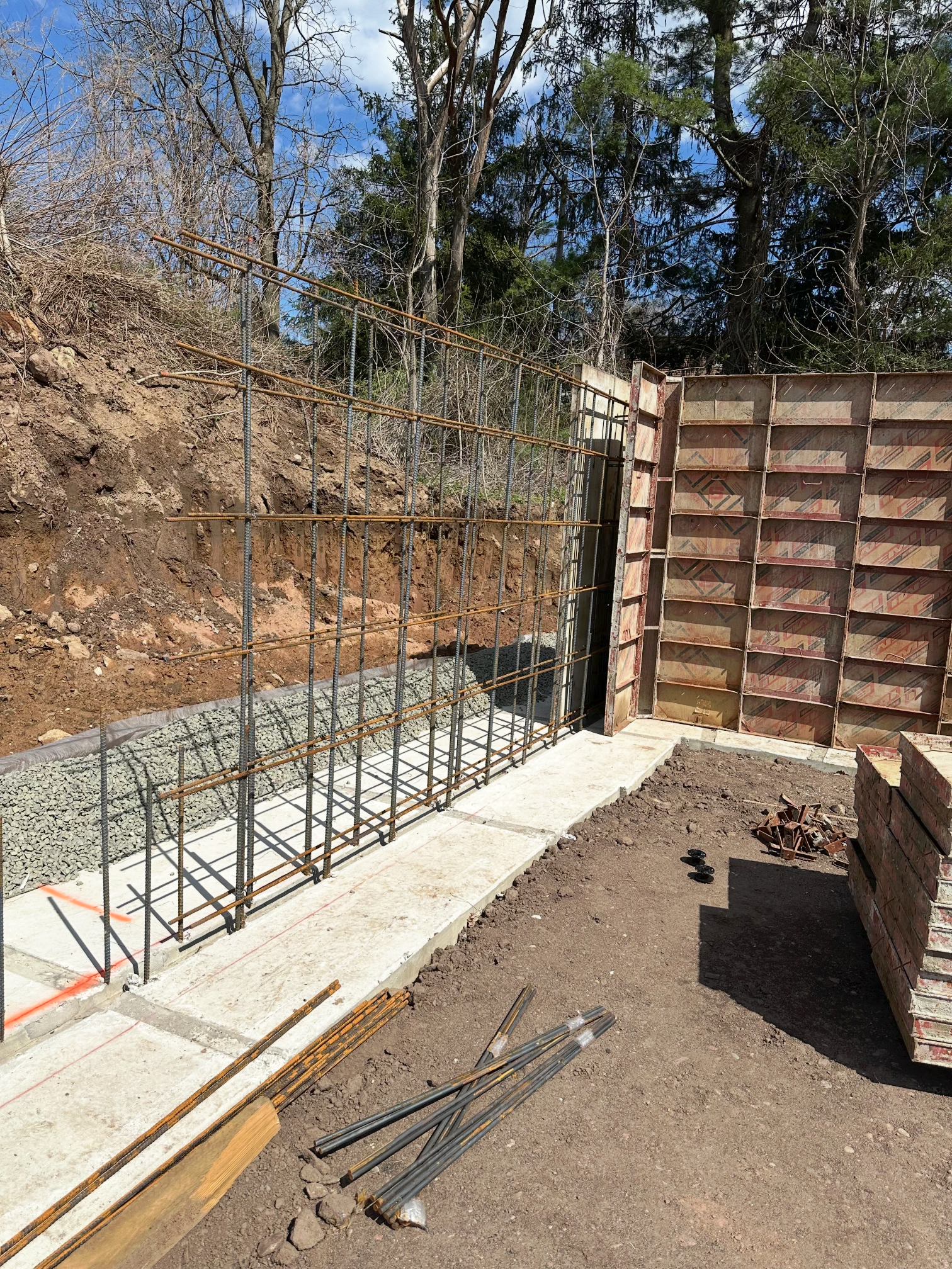 A fence is being built in the middle of a dirt field.