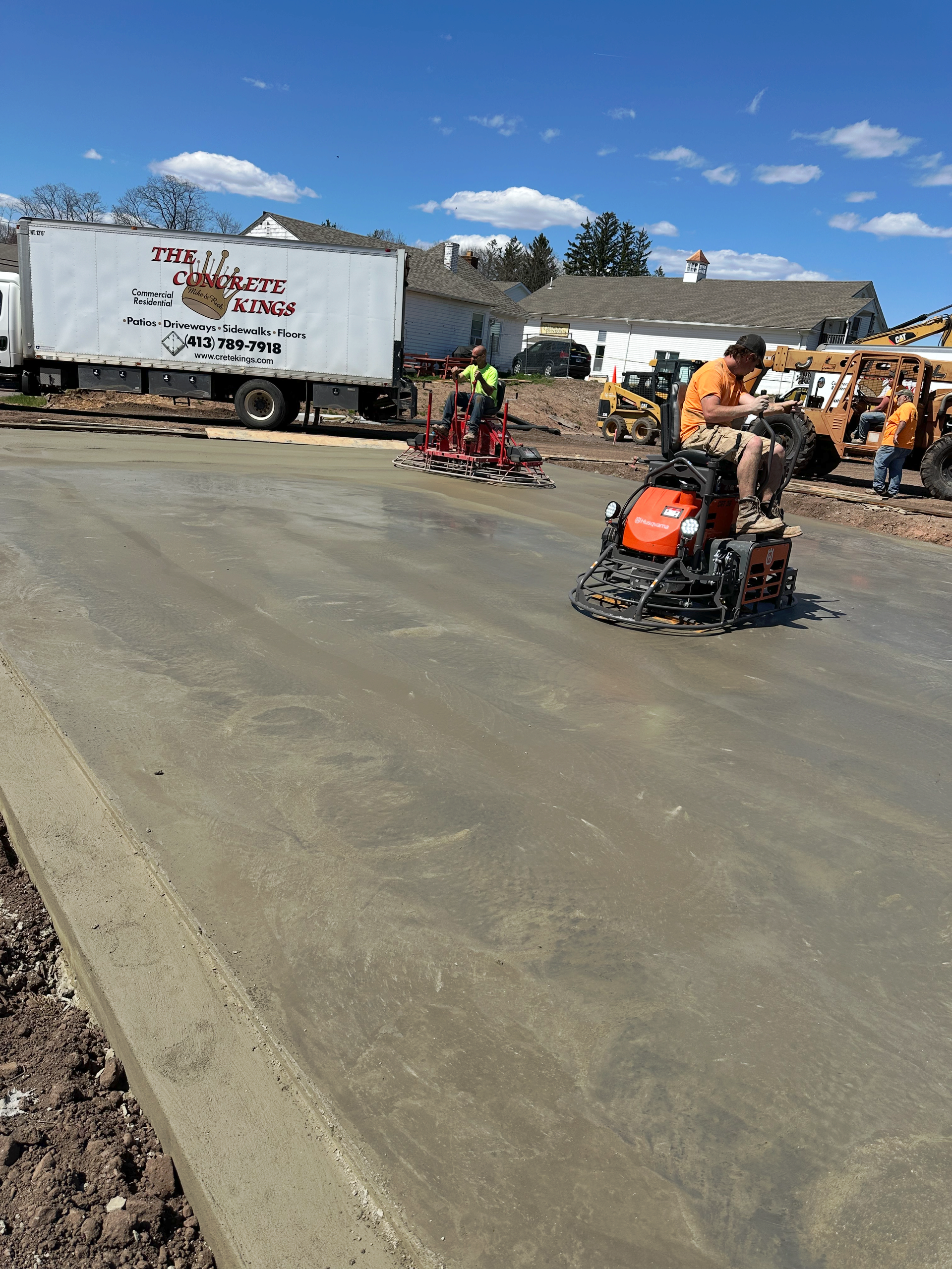 A man is riding a concrete grinder on a road
