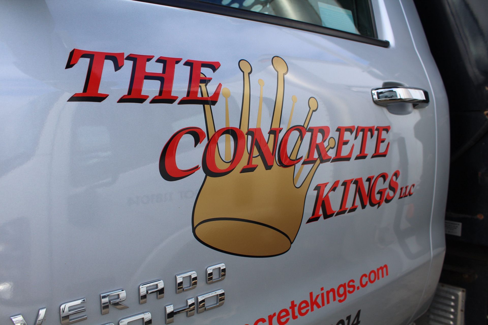 A silver truck with the concrete kings logo on it