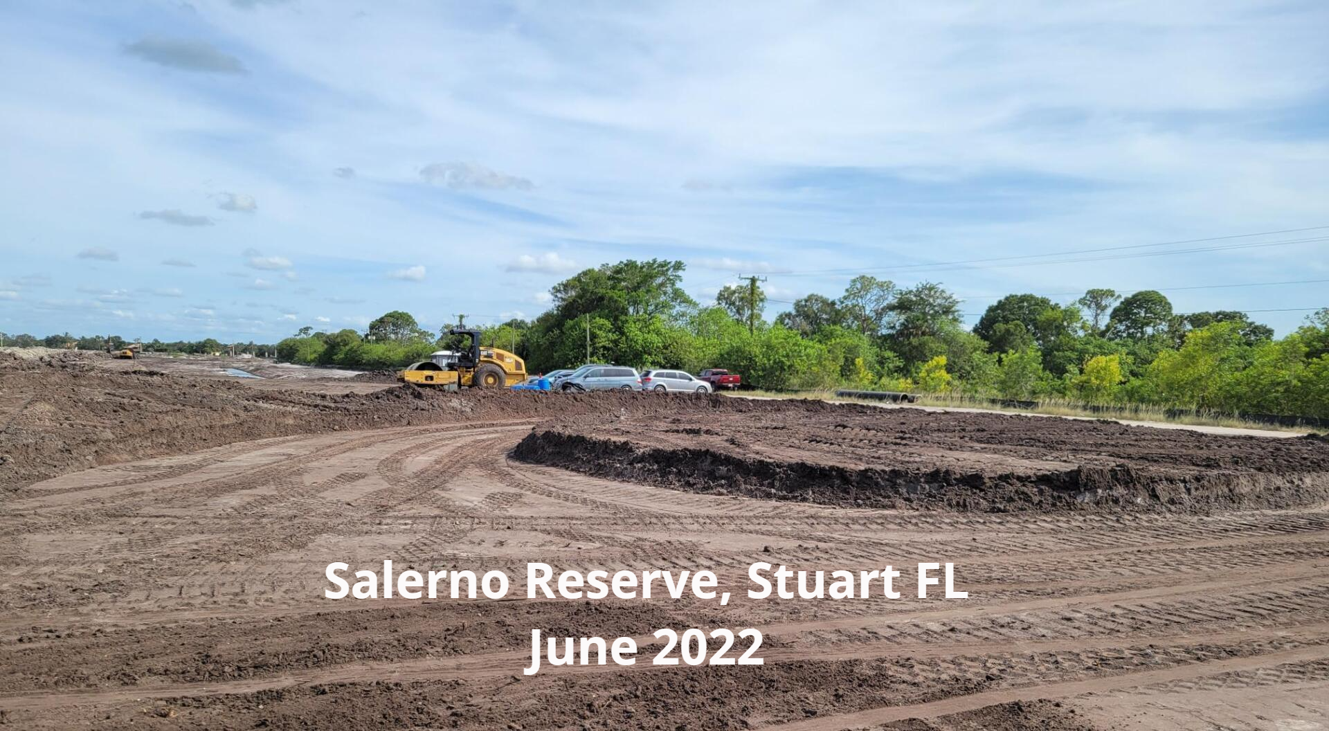 Construction site: Salerno Reserve, Stuart, FL, June 2022. Earthmoving equipment on a leveled, brown dirt field.