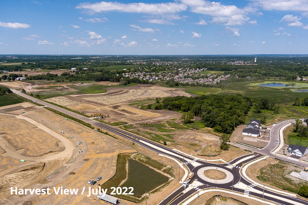 Aerial view of Harvest View construction site in July 2022, with a roundabout and partially cleared land.
