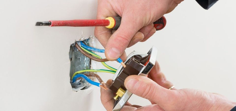 An electrician fixing a socket