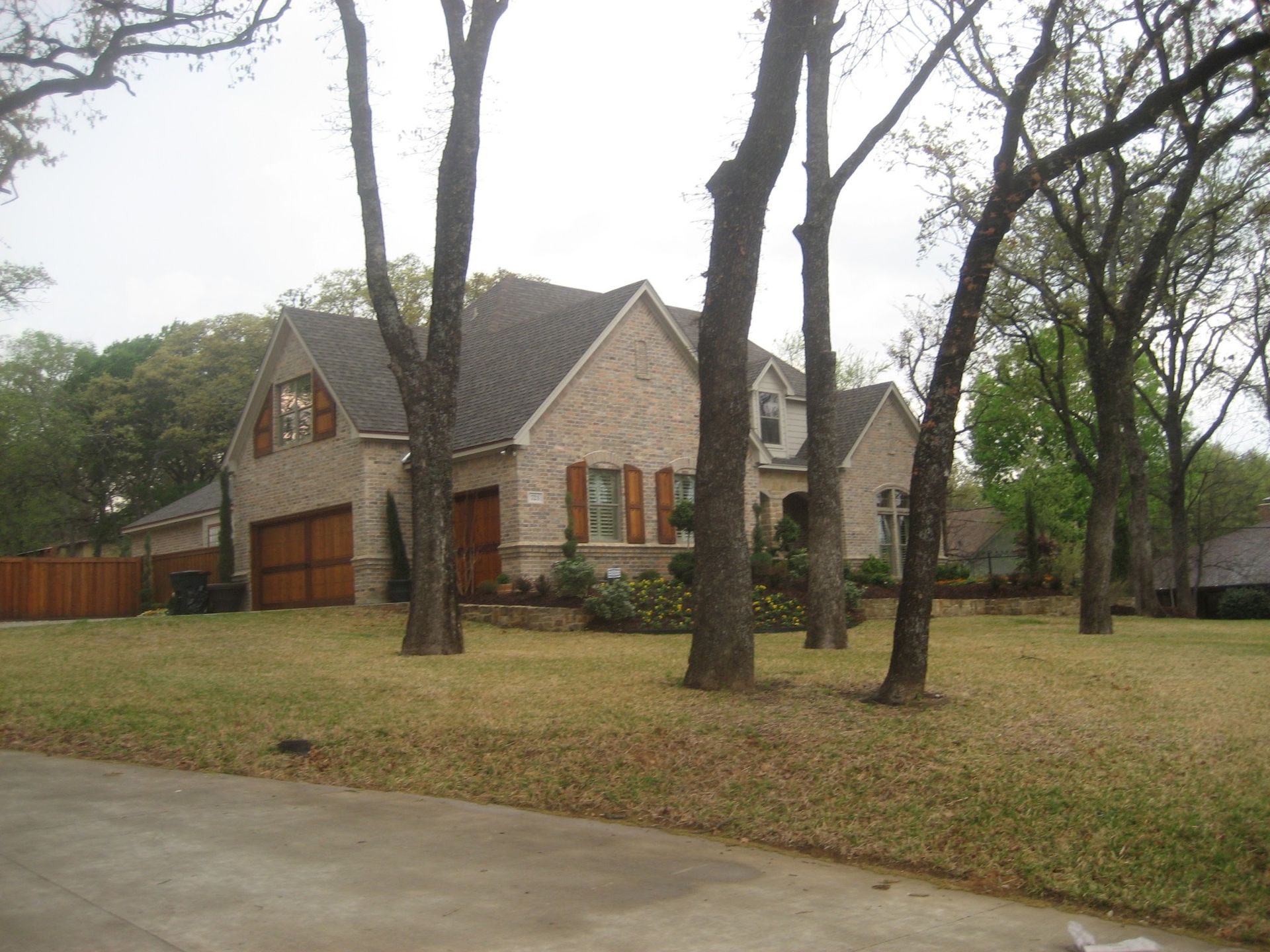 A large house with a lot of trees in front of it