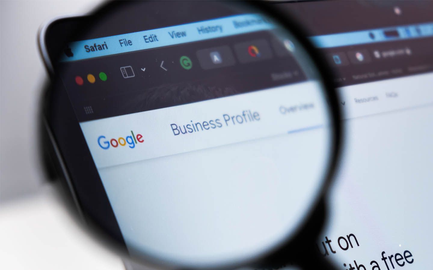 A magnifying glass is looking at a google business profile page