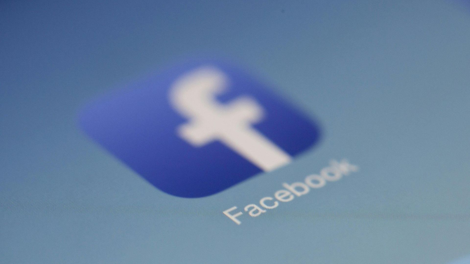 A close up of a facebook icon on a blue background