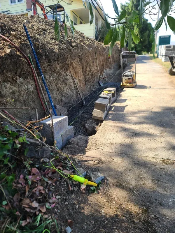 A large pile of dirt is sitting on the side of a road.