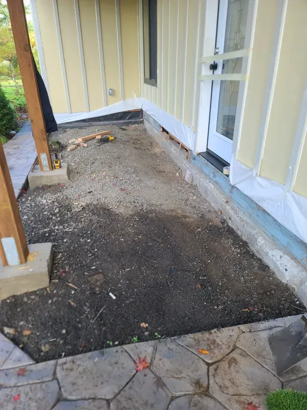 There is a lot of dirt on the ground in front of a house.