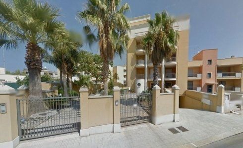 Un edificio con palme di fronte