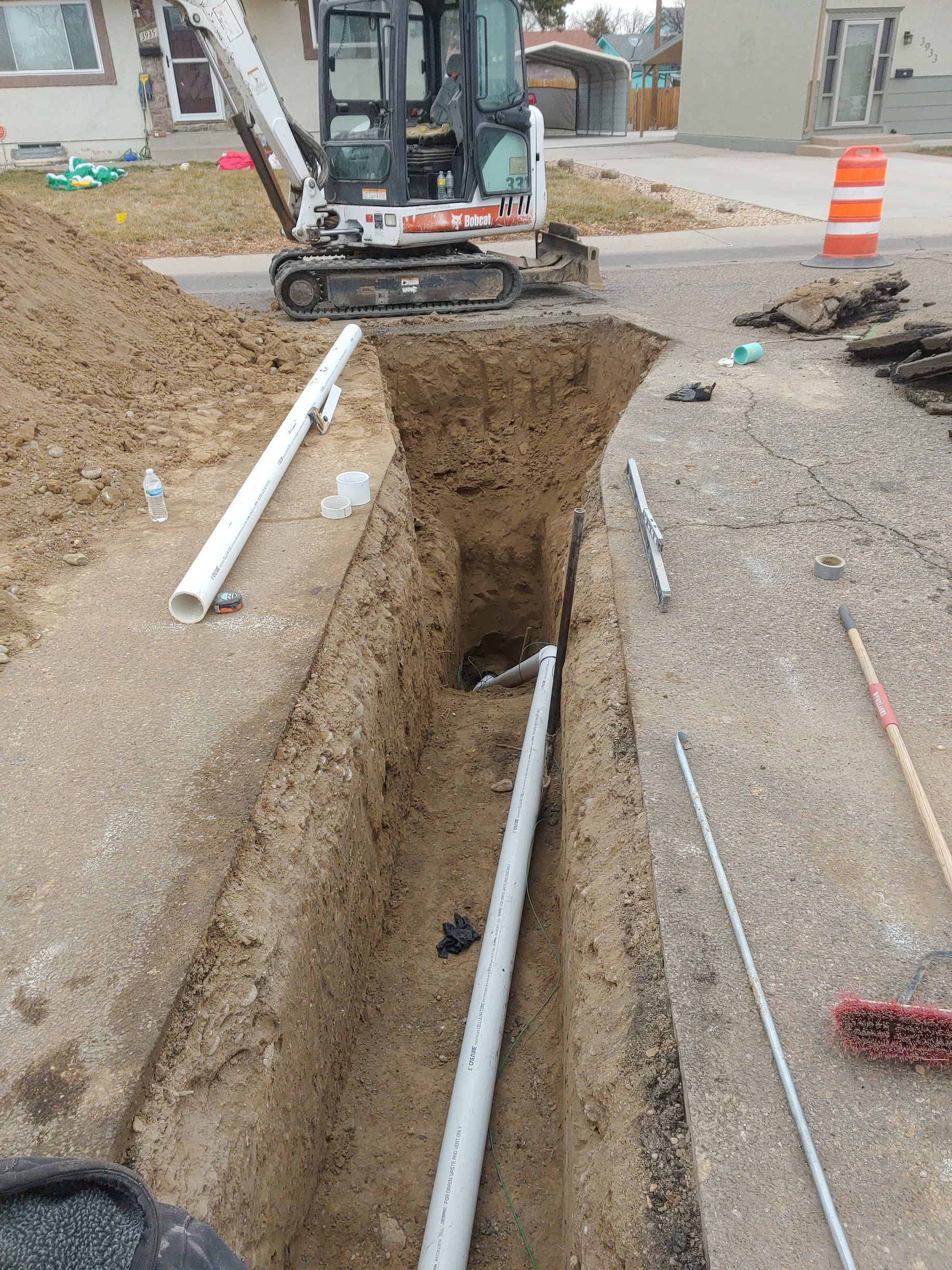 A small excavator is digging a hole in the ground.