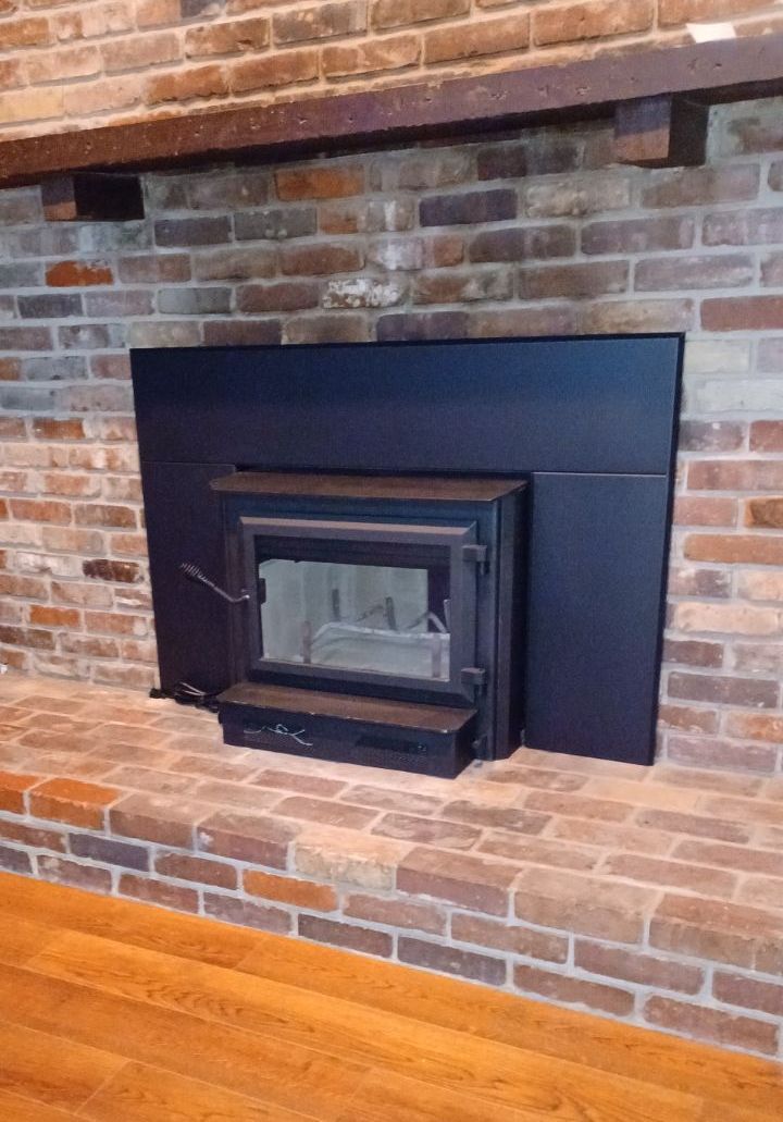 Contractor Builder with Blue Hardhat on the Roof Caulking Chimney – Evansville, IN – Pro Chimney Service