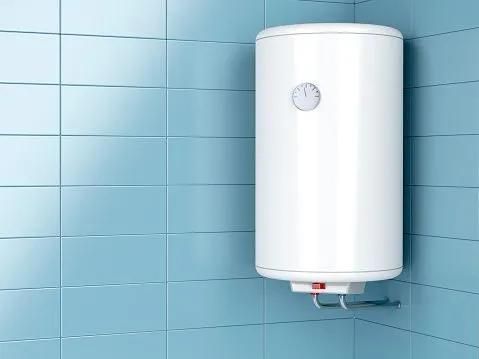 White water heater on a light blue tiled wall. It has a round dial and red button.