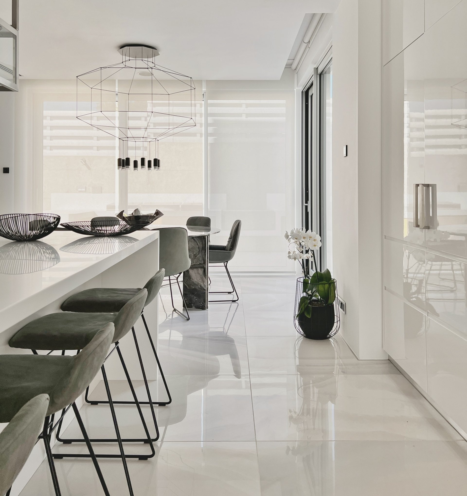 Kitchen area with focus on dining marble table, with view in the gardens