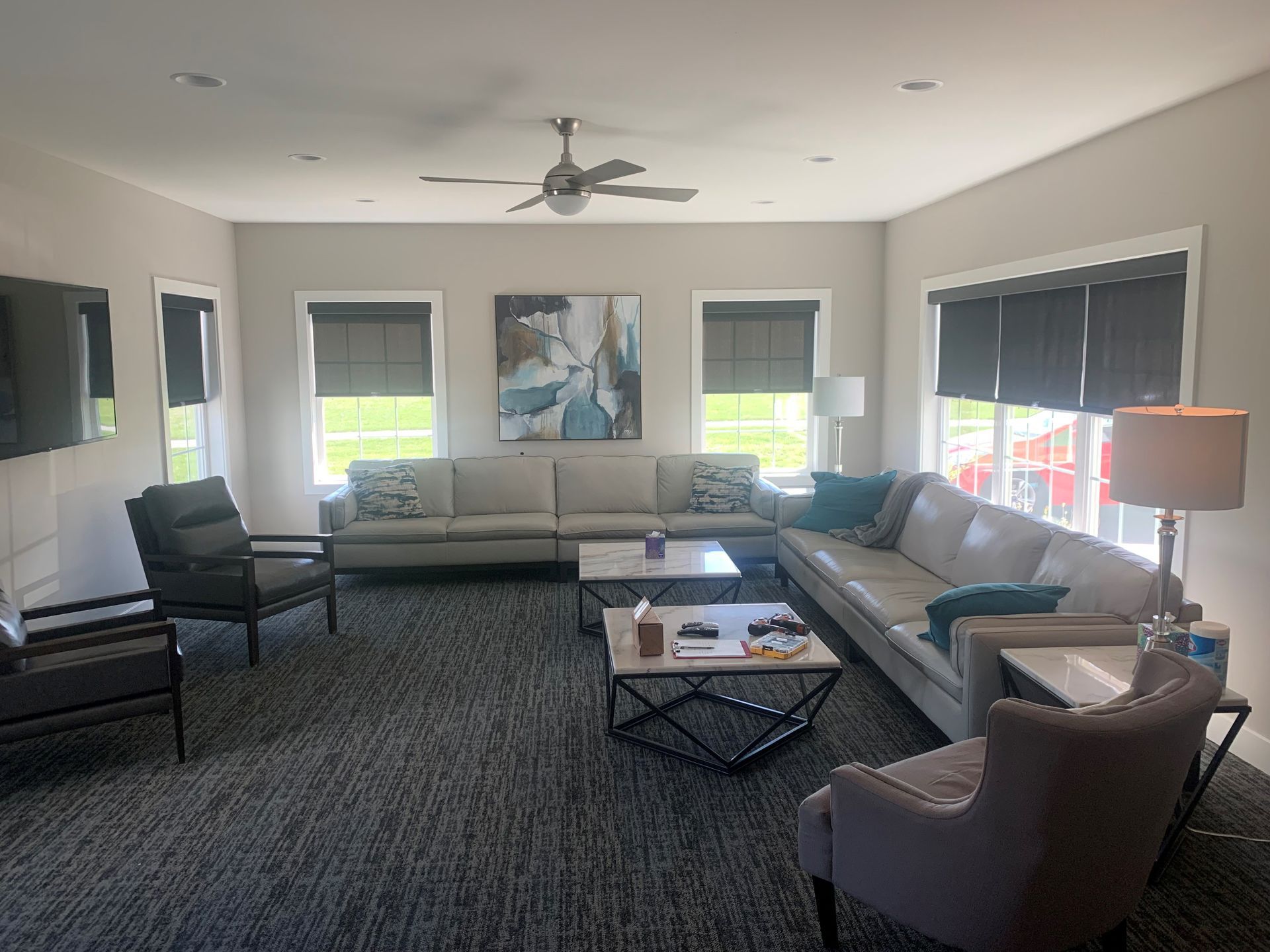 A living room filled with furniture and a ceiling fan.