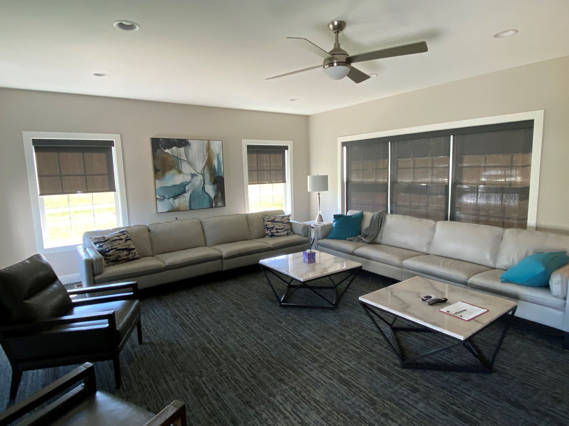 A living room filled with furniture and a ceiling fan.