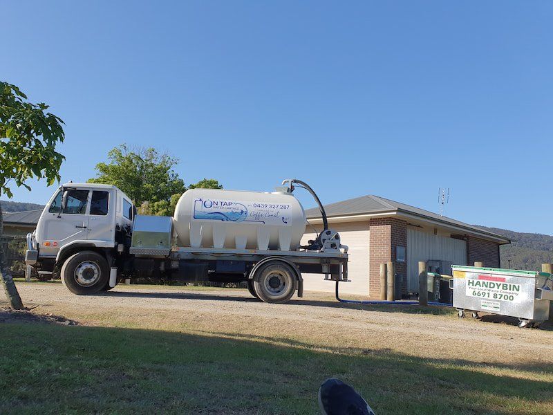 Man Carrying Water Jug — On Tap Water Cartage in Coffs Harbour, NSW