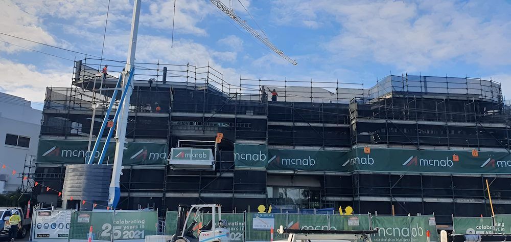 A Large Building is Being Built With Scaffolding and a Crane — All Coast Scaffolding In Yandina, QLD