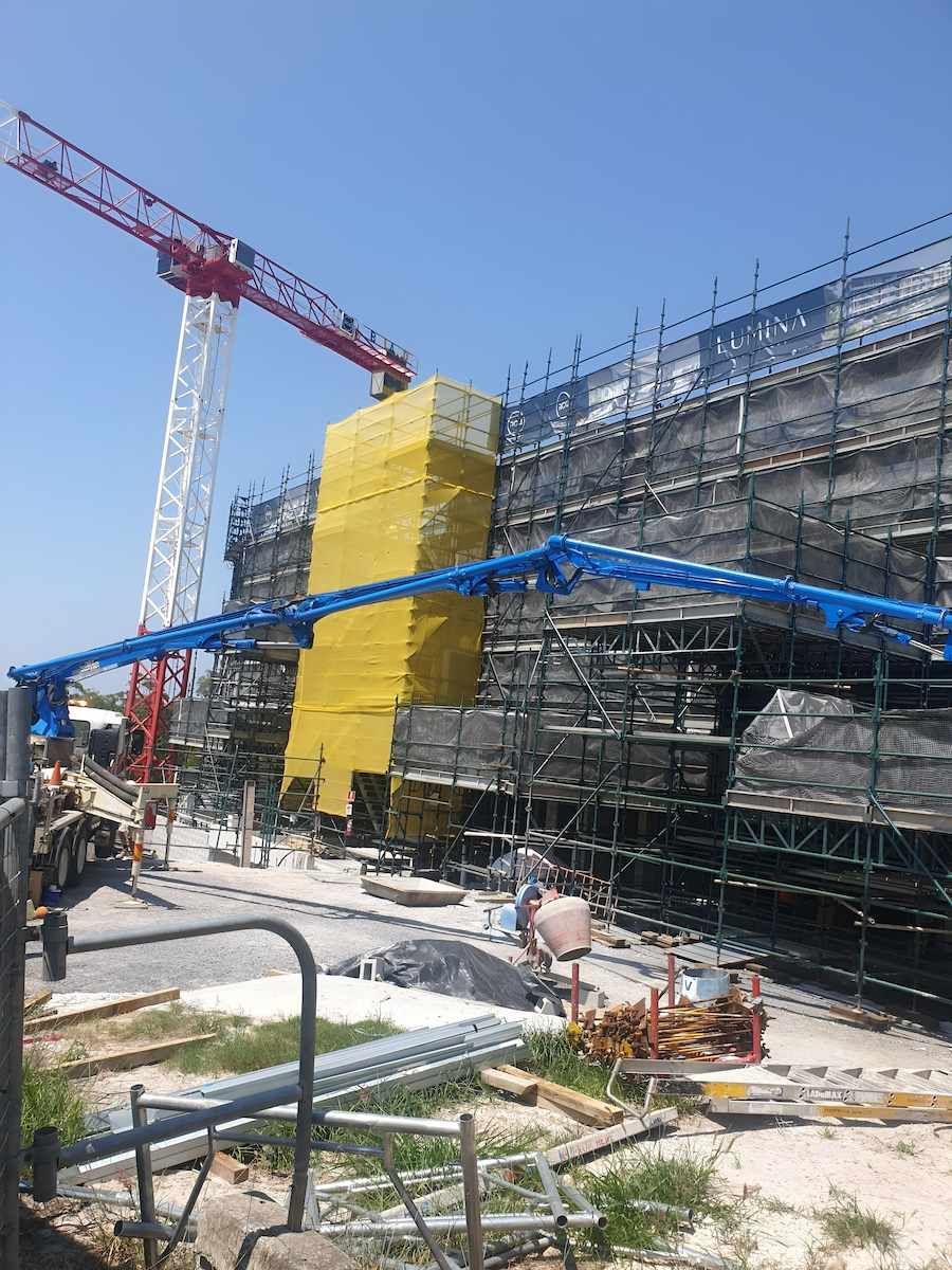 A Large Building is Being Built With Scaffolding and a Crane — All Coast Scaffolding In Yandina, QLD