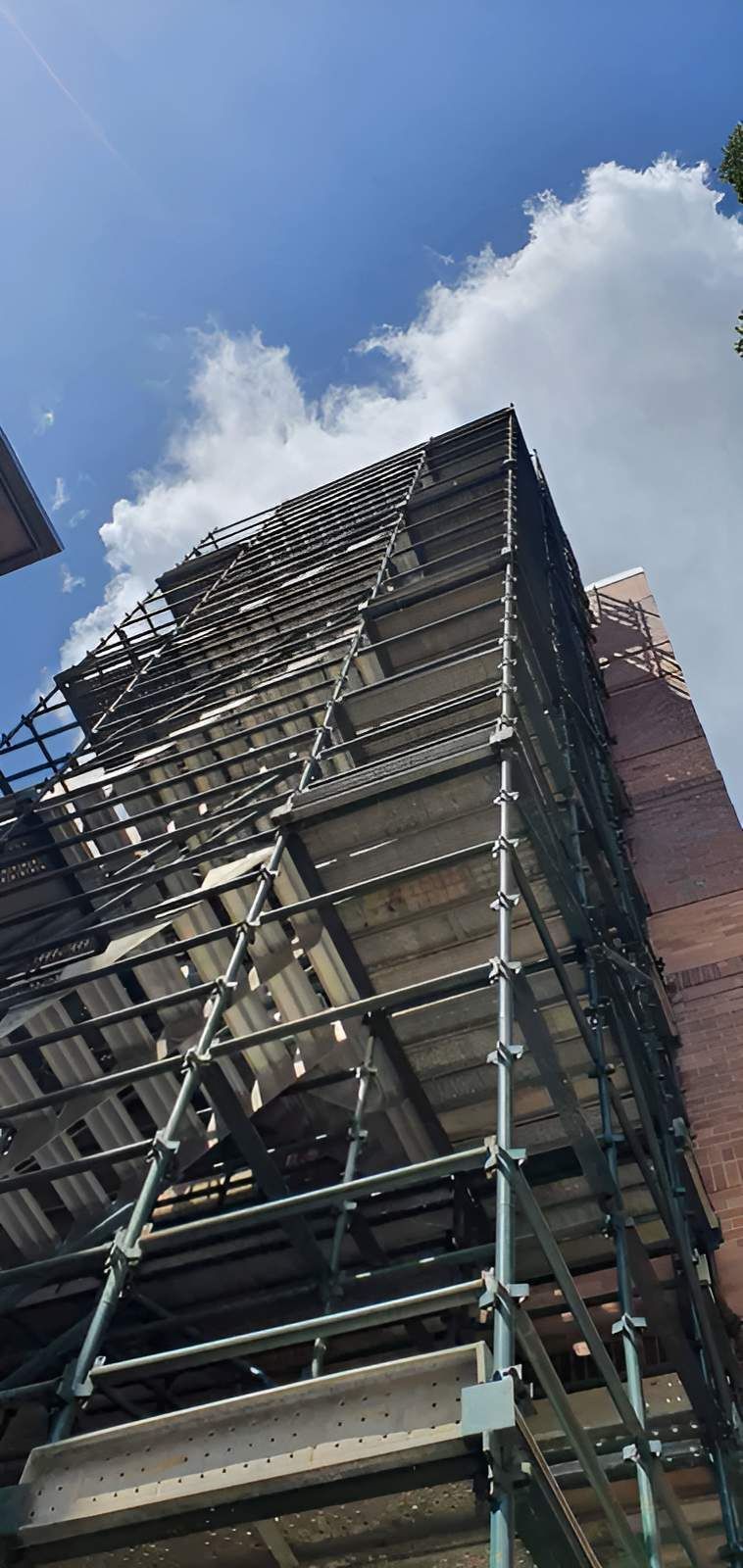 A Building is Being Built With Scaffolding Around It — All Coast Scaffolding In Pelican Waters, QLD