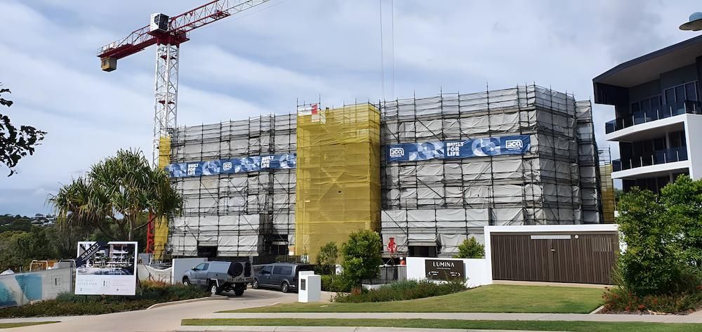 A Large Building is Being Built With Scaffolding and a Crane — All Coast Scaffolding In Yandina, QLD