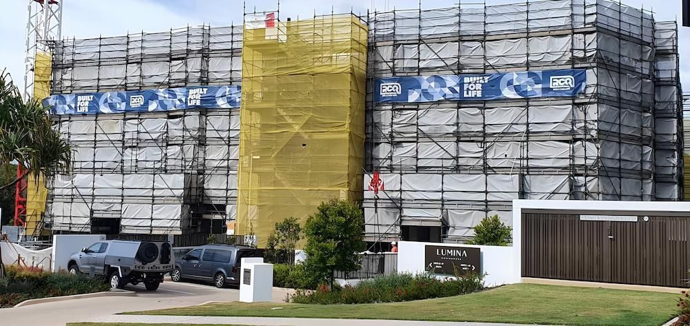 A Large Building is Being Built With Scaffolding Around It — All Coast Scaffolding In Yandina, QLD