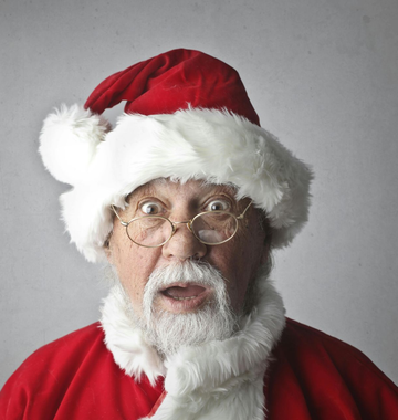 Santa Claus with surprised expression, wearing red hat and coat, looking at the viewer.