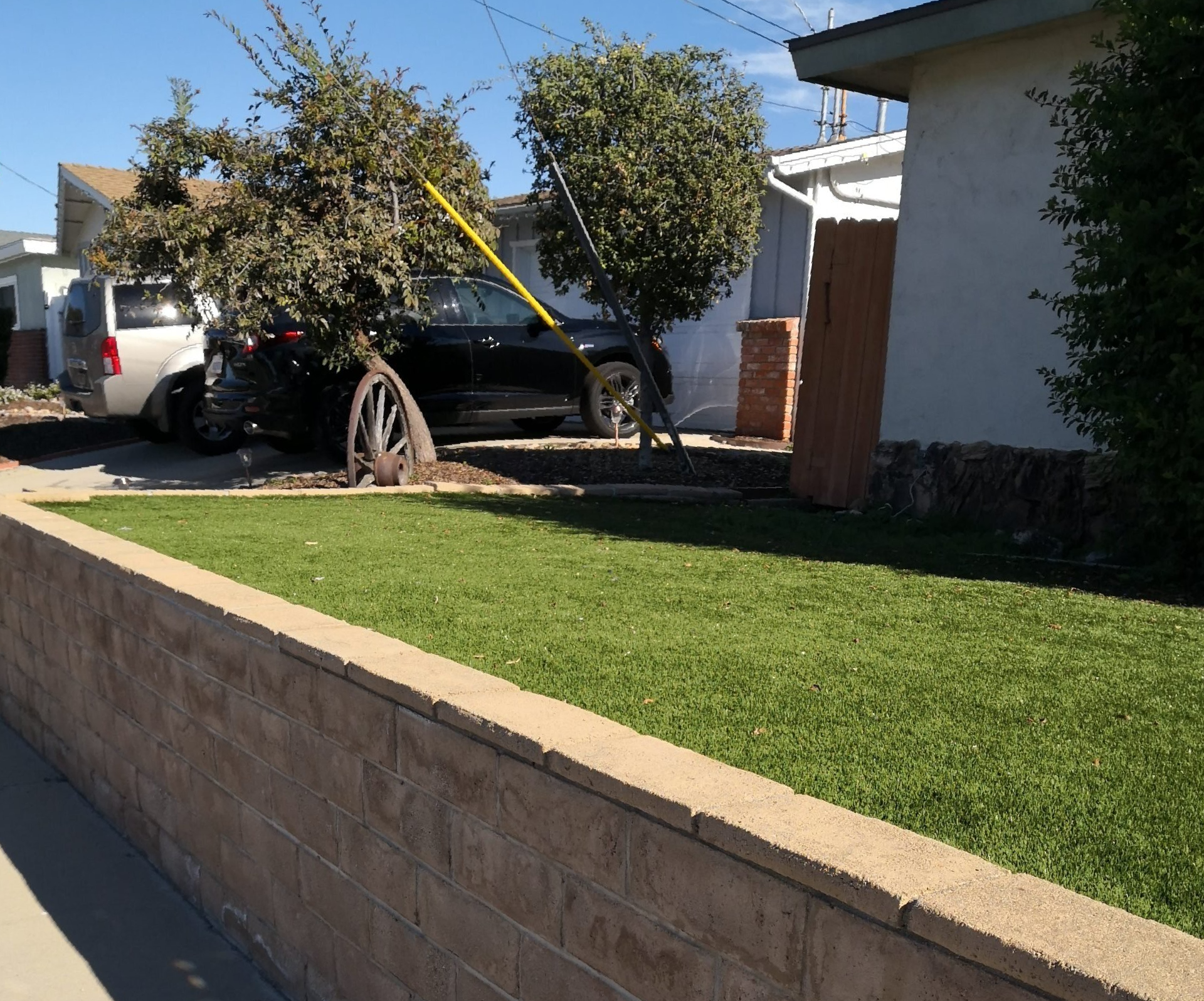 the artificial turf is laid next to the paved driveway in Scottsdale AZ