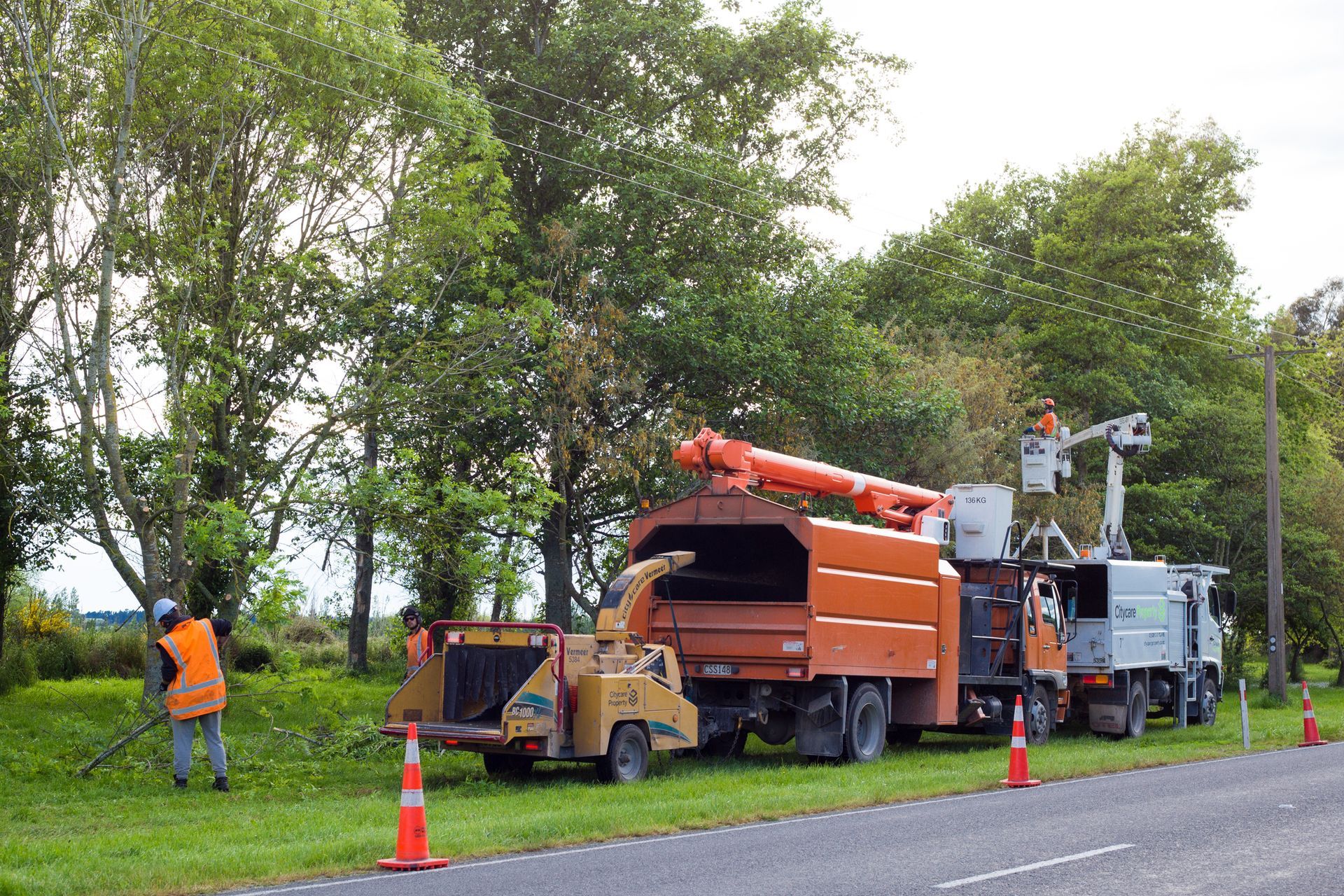 a group of trucks are parked on the side of the road .