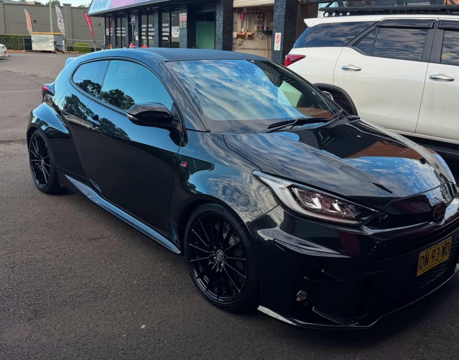 A Black Toyota is parked in Carpark with tinted windows — Rod's Total Tint In Thornton, NSW