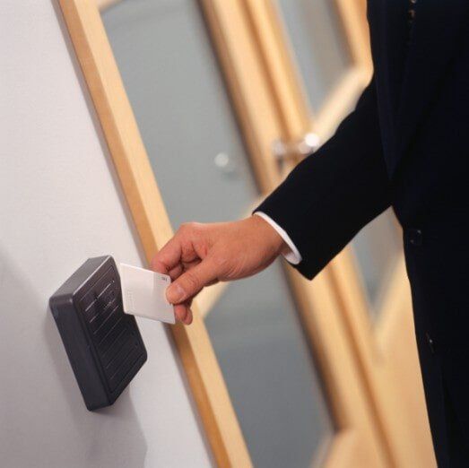 Businessman inserting card key into card reader — Advanced Alarm Company, Colorado Springs CO 80907, USA