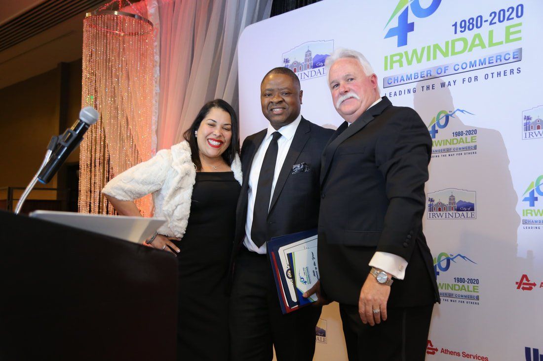 Three people are posing for a picture in front of a podium.