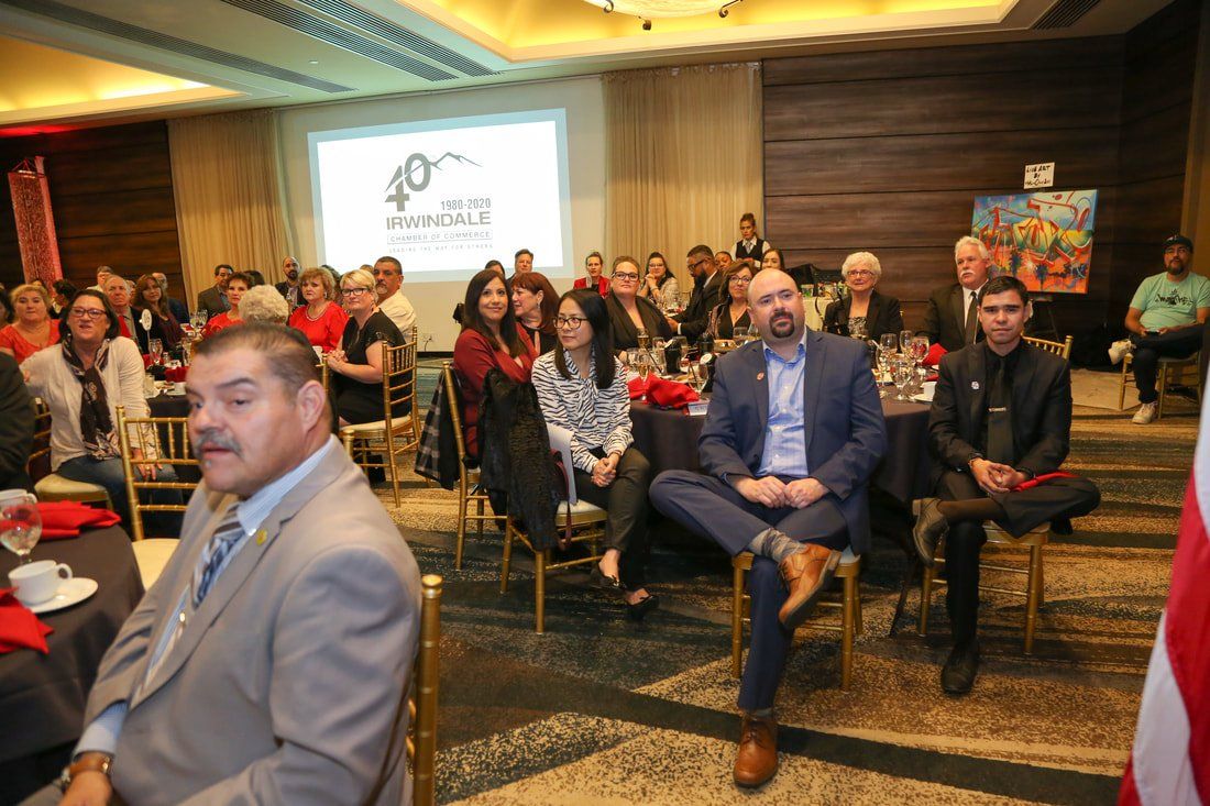 A group of people are sitting in chairs in a room.
