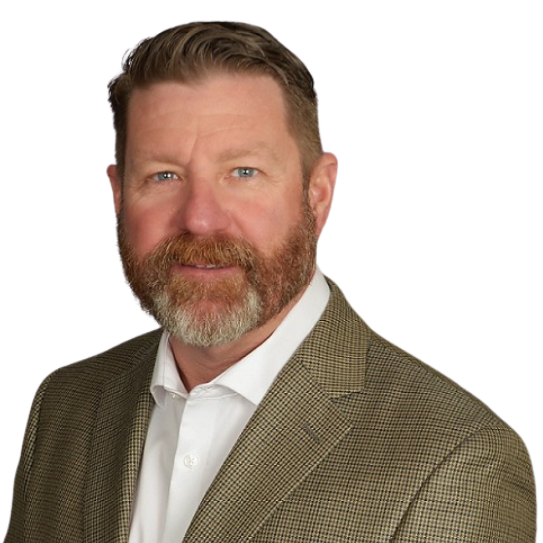 A man with a beard is wearing a suit and white shirt.