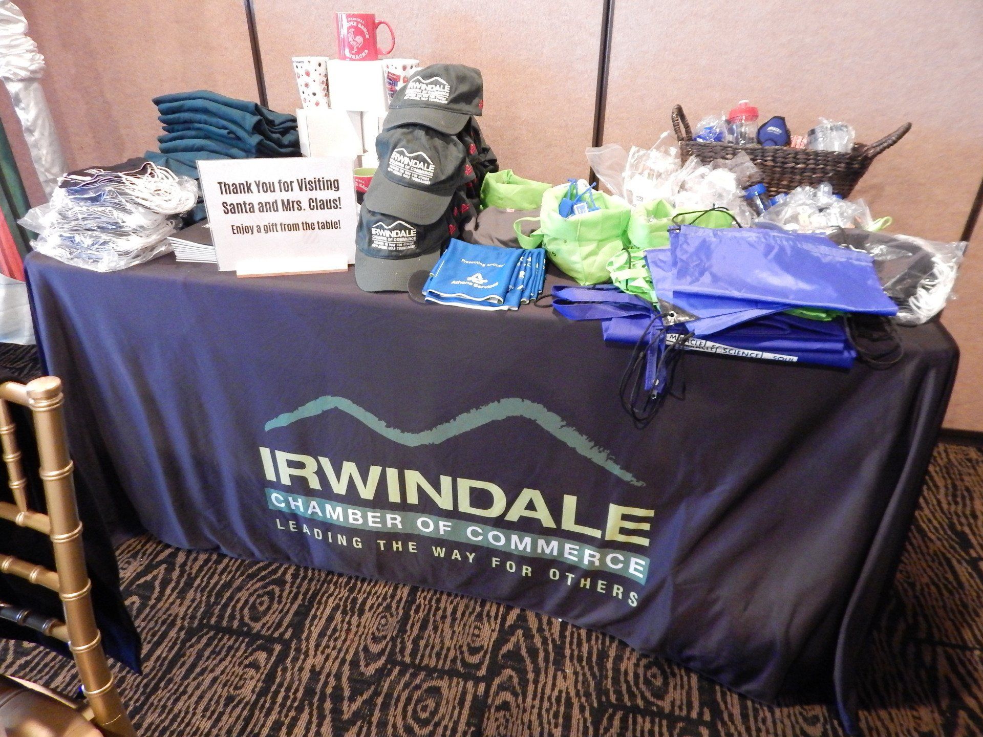 A table with a blue table cloth that says irwindale chamber of commerce