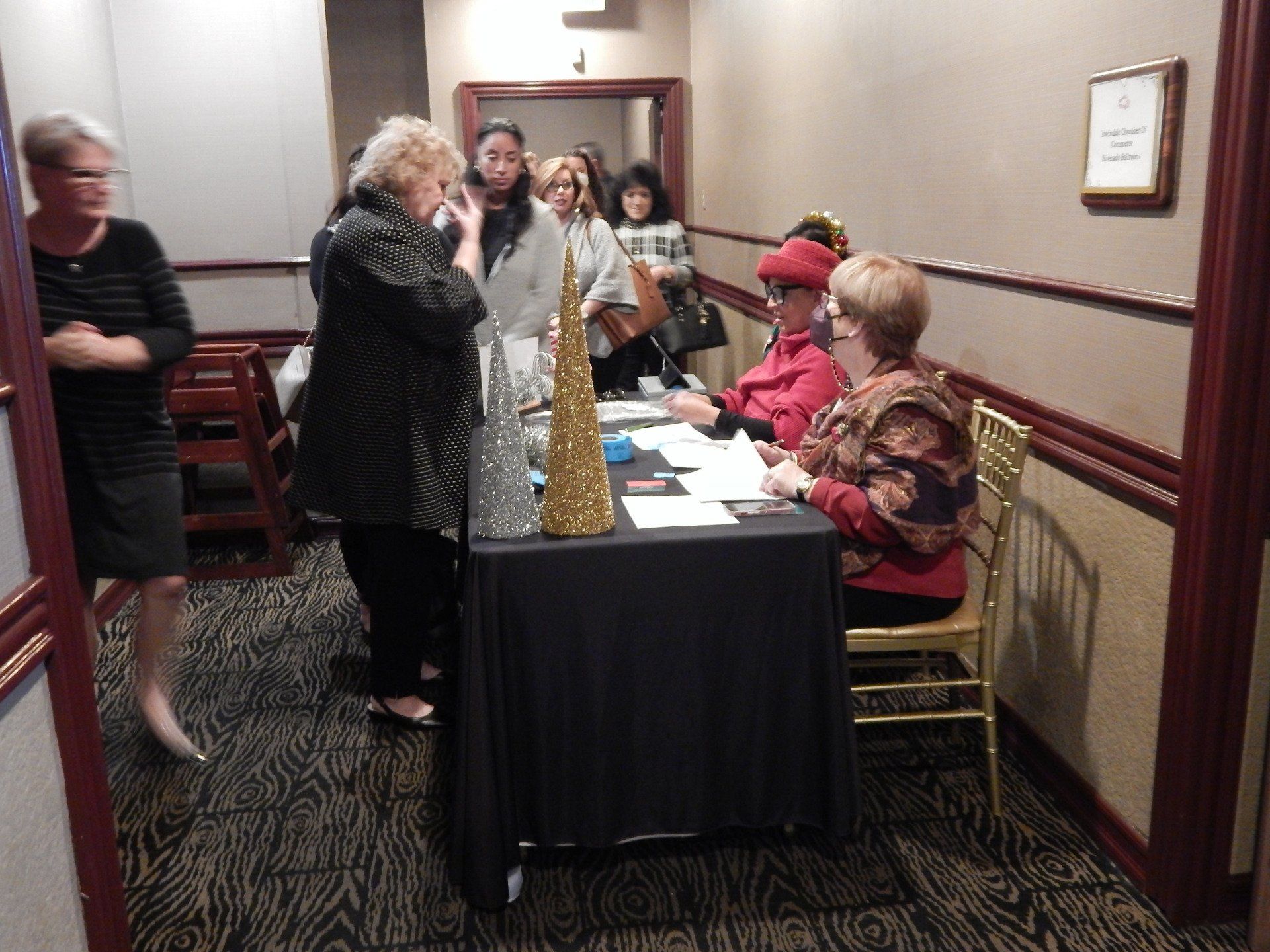 A group of people are standing around a table in a room