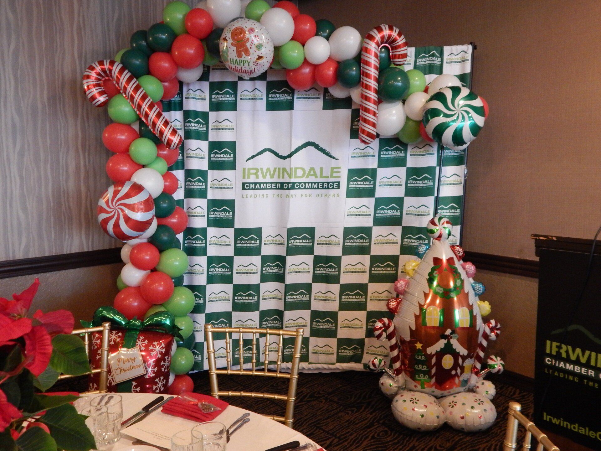 A room with a table and chairs decorated for christmas